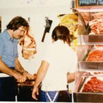 Mr Peter Black and his apprentice working in Peter's butcher shop, Arcade Meats