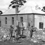 1921 - Local farmers, W. Flugge, J.C. Warren, unknown, and F.H. Flugge adding the supper room, using local stone