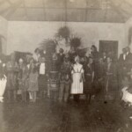 Social evening at the Rockwell Hall- after installing the ceiling and before the new floor boards were fixed. Jessie Warren, near centre as a puritan maid; Ernest Clegg left with white pants, Maybe 1924-7?
